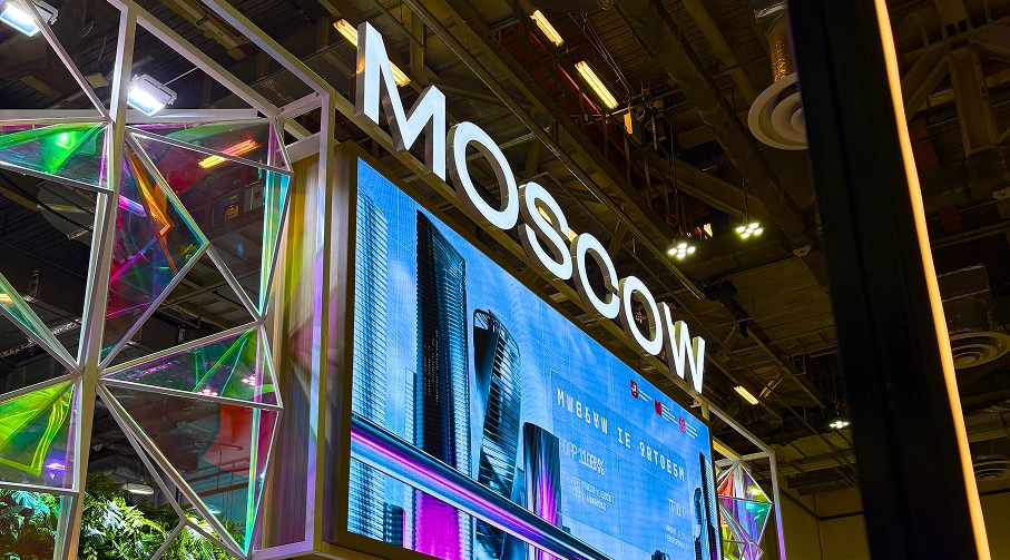 Exhibition booth design with large digital LED display wall and illuminated architectural signage